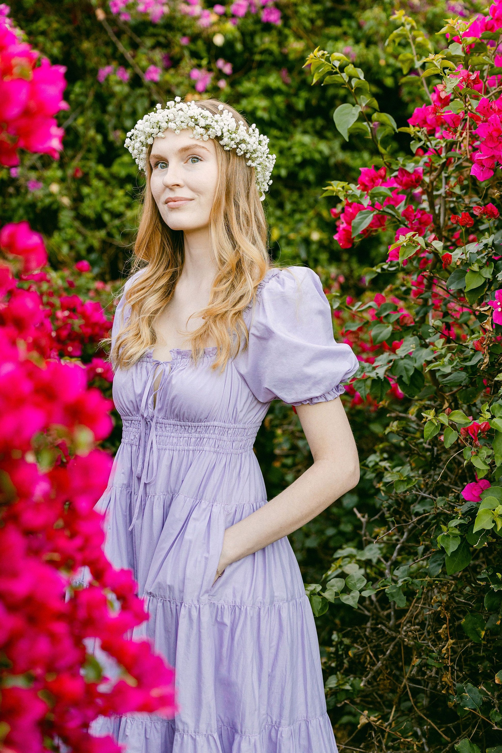 Model wears Penelope Midi Dress Lilac in secret garden