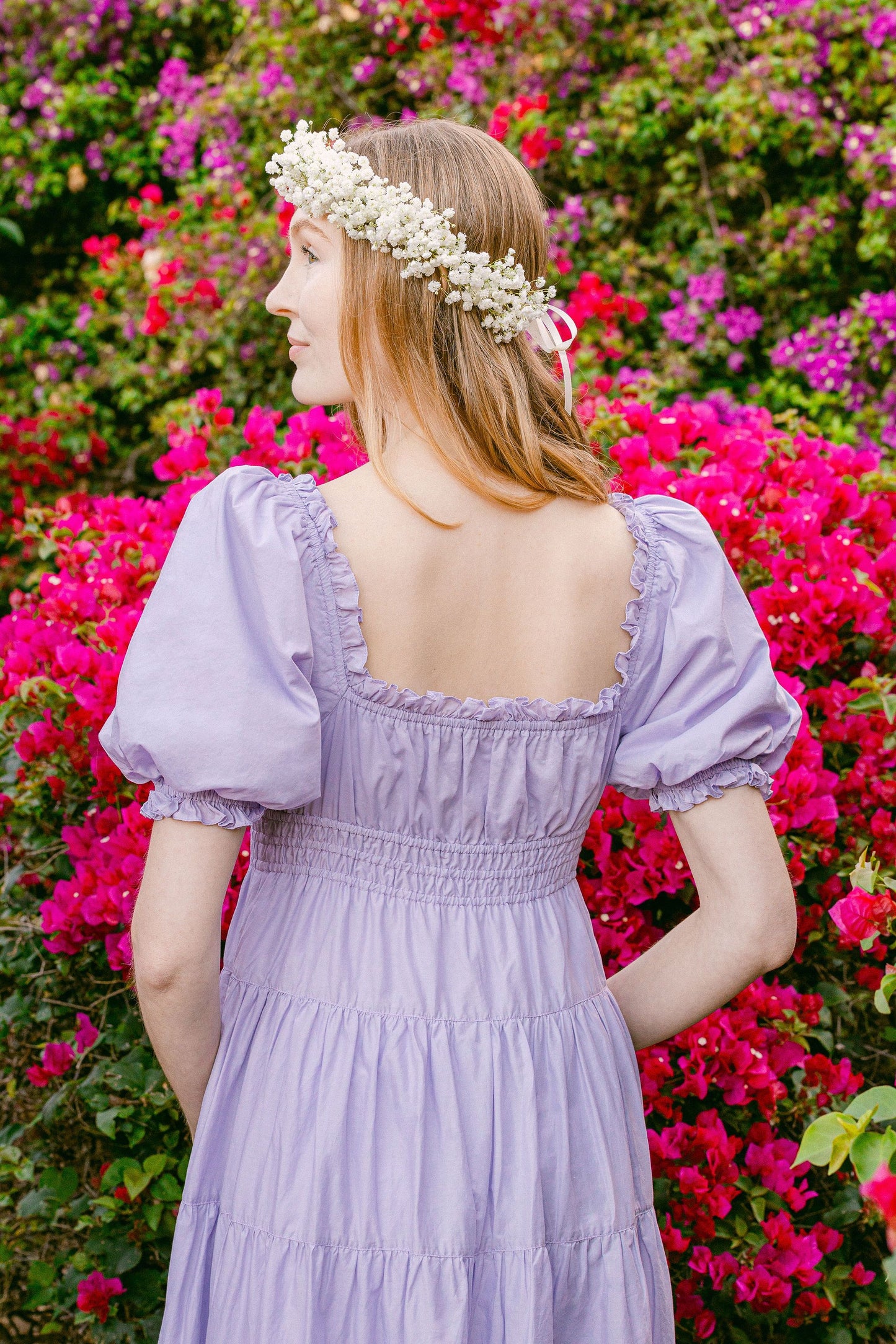 Model wears Penelope Midi Dress Lilac in secret garden