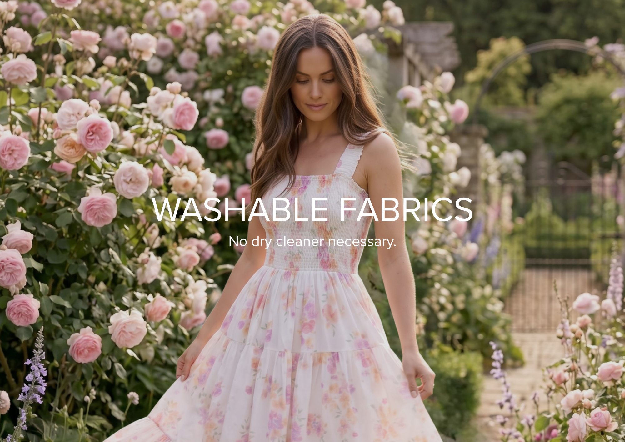 A woman in a white sleeveless dress leans against a rustic stone wall under bright pink flowers, with a text banner at the bottom reading 'DREAMY SILHOUETTES'.